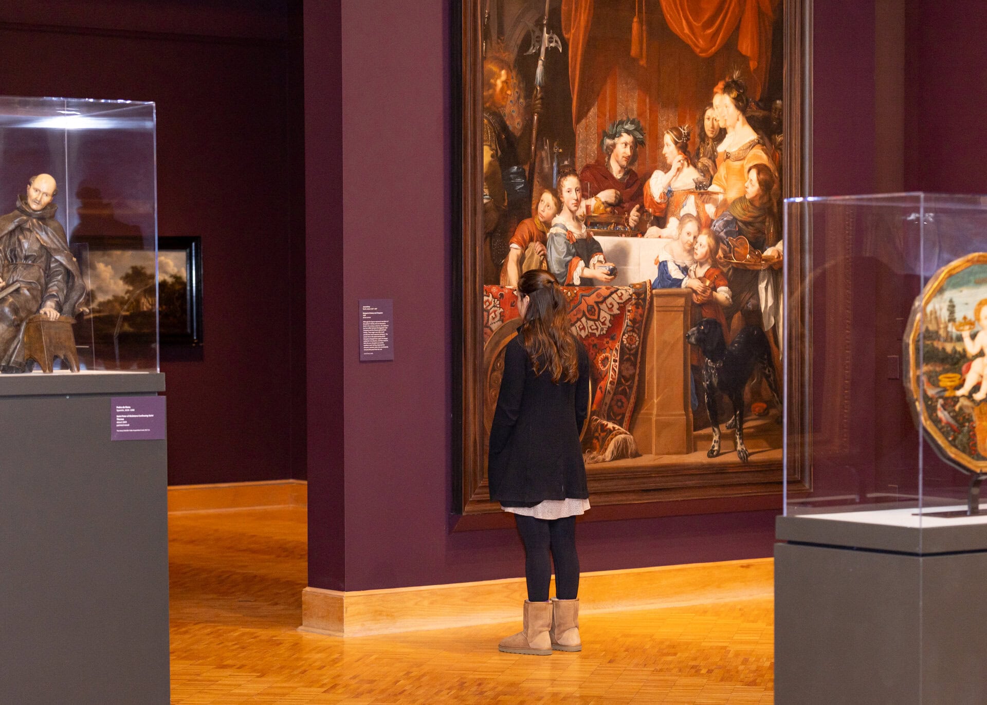 Patron standing in front of a painting at the Currier Museum.