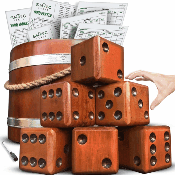 A set of large wooden dice stacked in front of a wooden bucket, with score sheets and a hand reaching for one die.